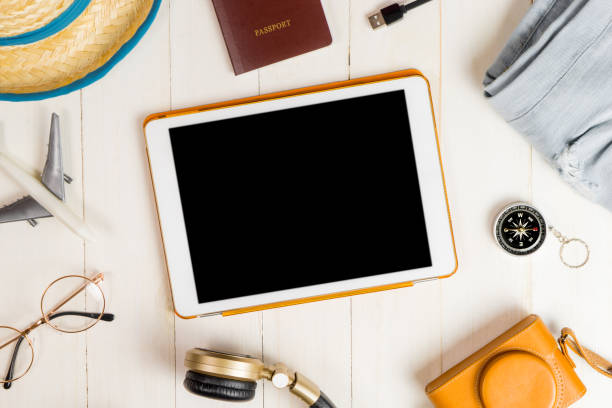 istock Blank tablet surrounded by summer travel equipment 821524824