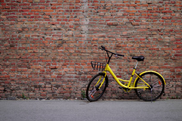istock Yellow Bicycle by the Brick Wall 821535690