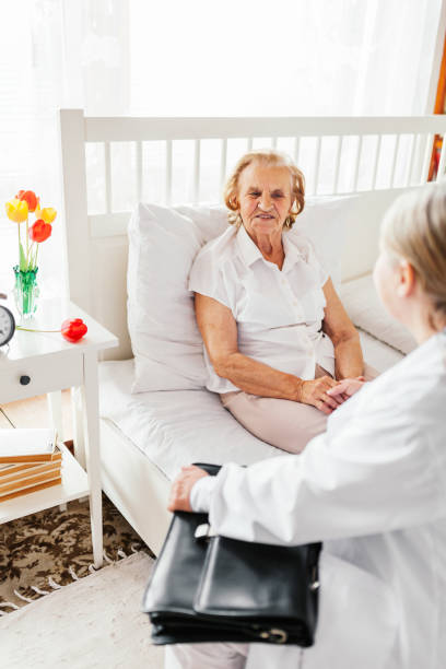 istock Providing care for elderly. Doctor visiting elderly patient at home. 821537900