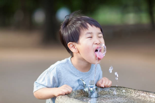 istock Boy Drinking Water From Water Fountain 821543478