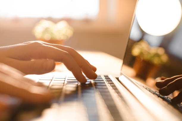 istock Hands working on the computer keyboard, pressing buttons, typing, simple close up with lens flare 821544162