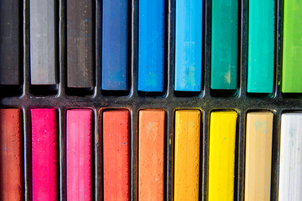 Set of colorful chalk stick on black tray