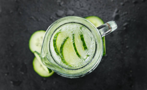 istock Some Cucumber Water on a dark slate slab 821552354