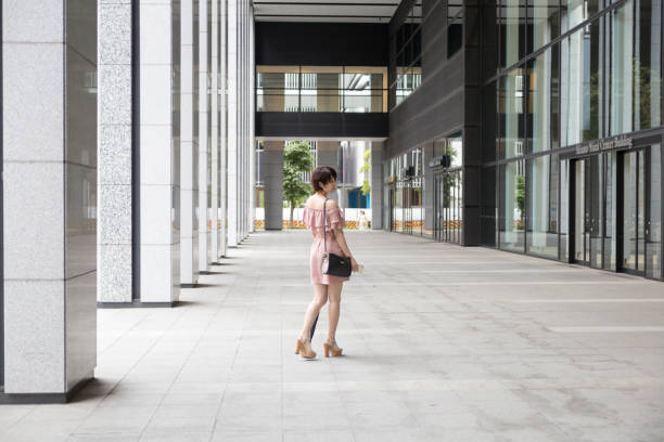 istock cute Japanese woman riding the escalator 821555576