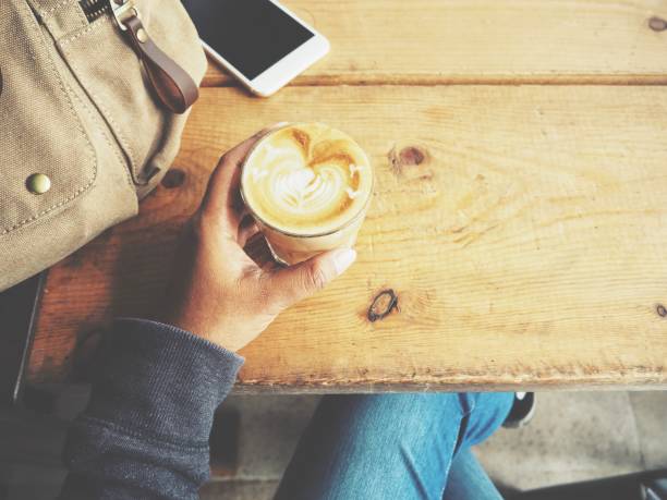 istock Woman drinking coffee with smart phone 821555932