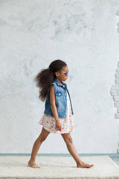istock Cute afro girl against the gray wall 821558874
