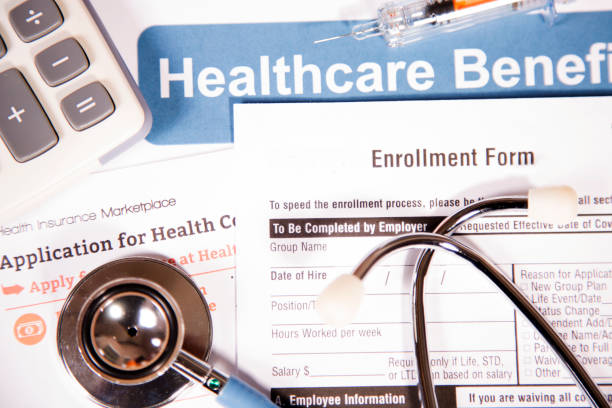 Healthcare benefit forms including: enrollment forms and applications, stethoscope and other medical and office items.  Affordable healthcare remains an important topic around the world!