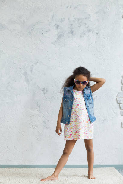 istock Cute afro girl against the gray wall 821561924