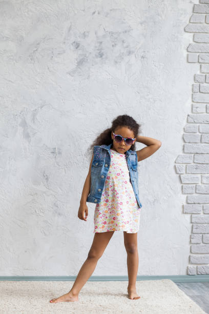 istock Cute afro girl against the gray wall 821563200