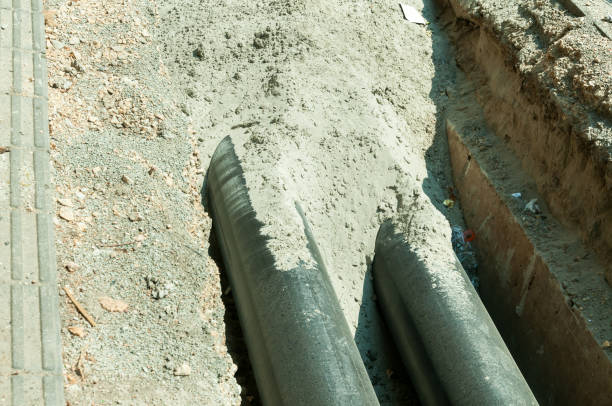 istock Work in progress, burying pipeline in a urban area. 821565392
