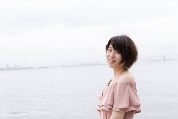 istock pretty woman in front of the coast 821565580