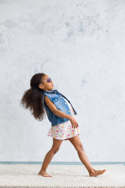 istock Cute afro girl against the gray wall 821566176