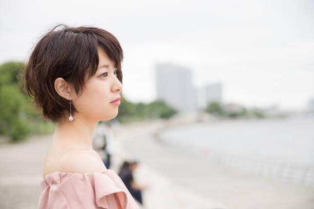 istock pretty woman in front of the coast 821568314