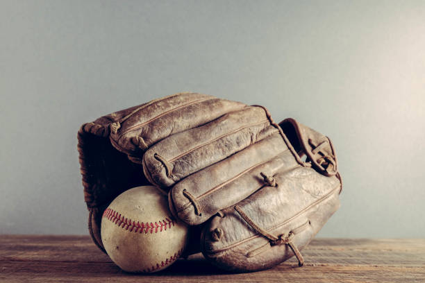 istock old Baseball and glove on wood background with filter effect retro vintage style 821568772