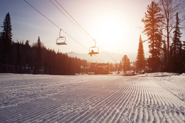 istock Ski lift and Snow surface groomed and prepared for alpine skiing 821569172