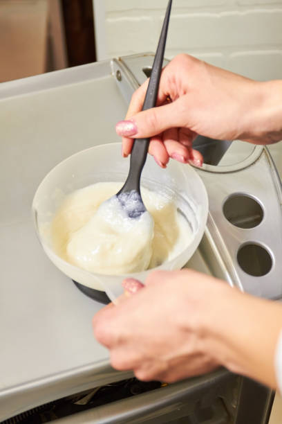 istock Hands mixing hair dye, bowl. 821569698
