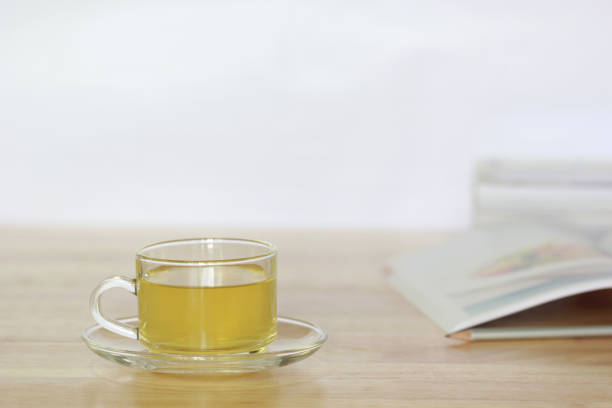 istock Tea cup and a books on the wooden table 821572644