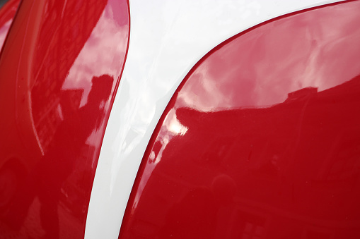 curved car form in red and white color, glossy automotive paint