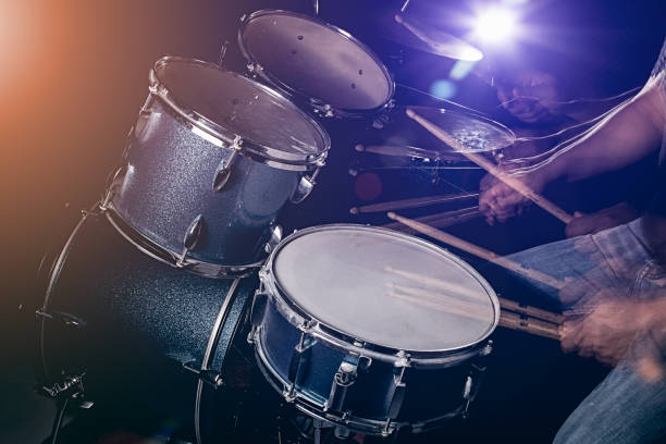 istock The man is playing drum set in low light background. 821588392