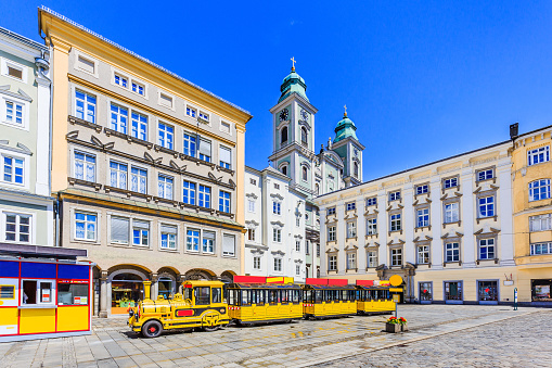 Linz, Austria. Old Cathedral (Alter Dom) and tourist train in the Main Square (Hauptplatz)