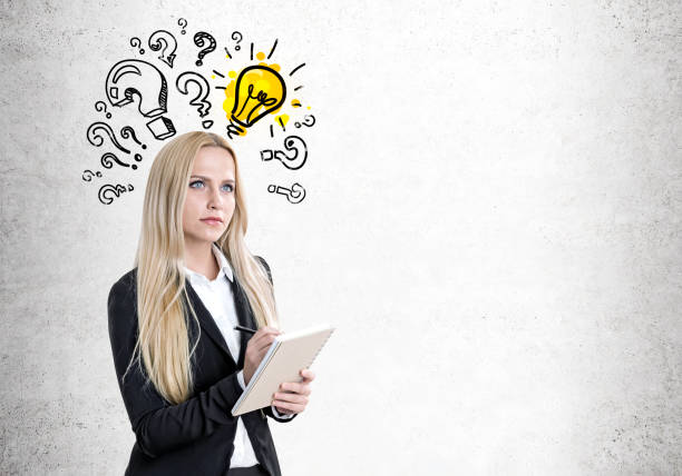 istock Blond woman with a copybook, questions, bulb 821594124
