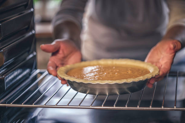 istock Baking Pumpkin Pie for the Holidays in the Oven 821594850