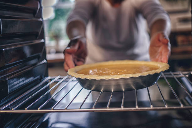 istock Baking Pumpkin Pie for the Holidays in the Oven 821594882