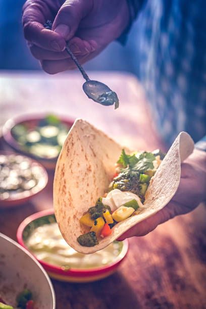 istock Preparing Mexican Tacos with Spicy Salsa and Shrimps 821595666