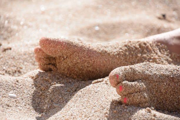 istock Legs in the sand at the beach 821601246