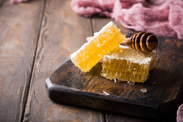 istock Honeycomb on old wooden cutting board 821605016