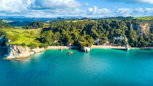 Aerial view on a remote ocean coast with small coves and mountains on the background. Coromandel, New Zealand. Cathedral cove, Coromandel peninsula, New Zealand coromandel peninsula stock pictures, royalty-free photos & images