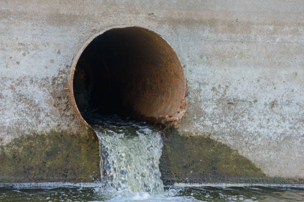 istock Dirty water flows out of a large rusty metal pipe 821605960