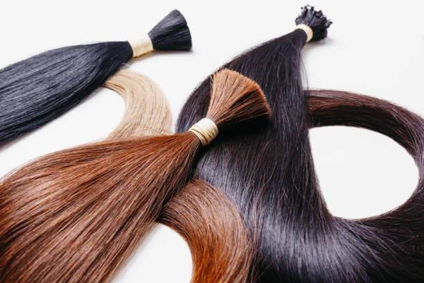 hair extensions of three colors on a white background. copyspace selective focus hair extensions of three colors on a white background hair extension stock pictures, royalty-free photos & images