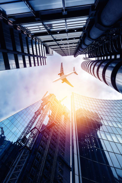 istock Airplane flying above skyscrapers 821608376