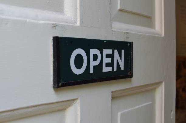 istock Open sign on white door. 821611912