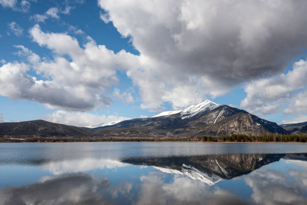 Dillon Reservoir in Colorado with cloud reflection and snow capped mountain Slightly distorted reflection of mountain and snow in Silverthorne Colorado summit county stock pictures, royalty-free photos & images