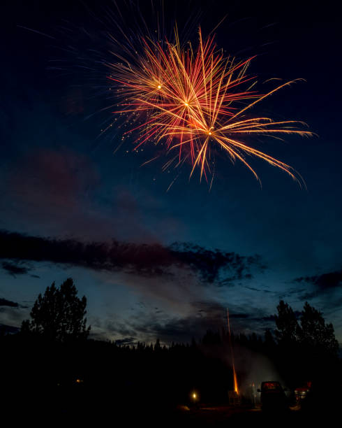 istock Unique view from behind a firework show in the blue sky of early evening 821615172