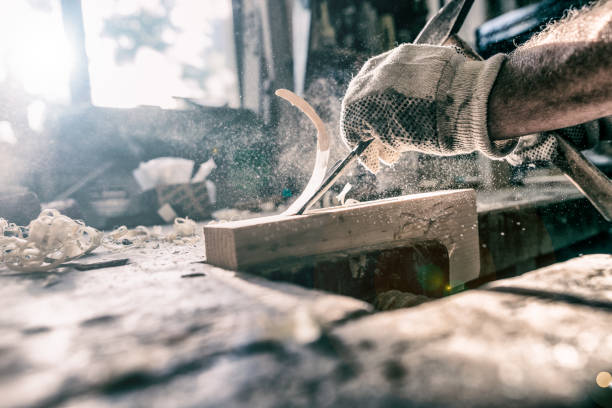 istock An experienced carpenter shapes wood with a chisel 821618622