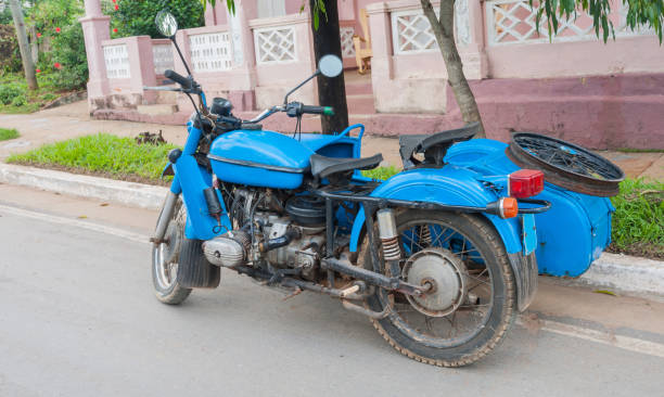 istock Old bright blue motorcycle with side car parked in Cuban street. 821621598