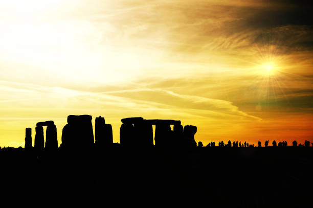 istock Stonehenge silhouette under bright orange sky/skies 821625486
