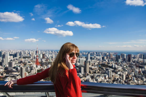 istock Woman looking at Tokyo from rooftops. 821630720