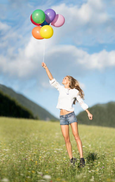 istock Woman being pulled in the Air by Balloons 821630920