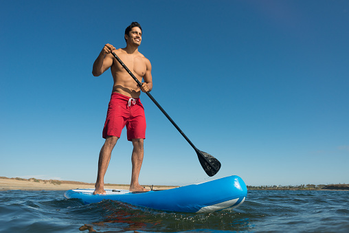 Man Stand Up Paddle Boarding in Mission Bay.