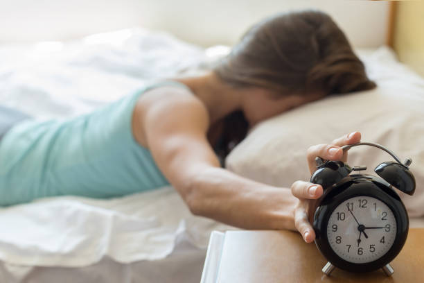 Wake up of a girl stopping alarm clock Wake up of a girl stopping alarm clock horror waking up bed women stock pictures, royalty-free photos & images