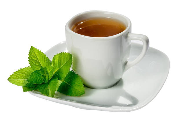 istock white tea cup and sauser with hot tea and mint leaves isolated on white background 821637270
