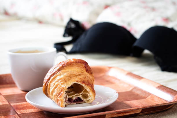 istock Tasty breakfast to bed. Croissant with coffee. White background. 821637548