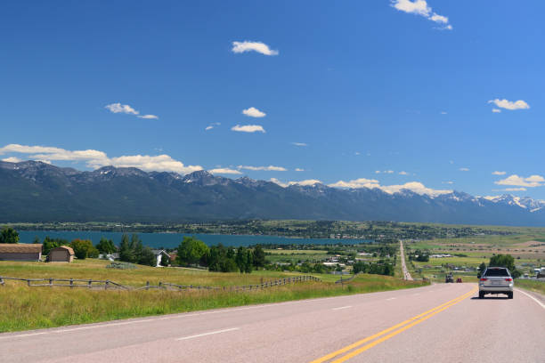 Cumulus clouds start to gather over the mountains as the afternoon wears on at the rural town of Polson, MT along the Flathead Lake