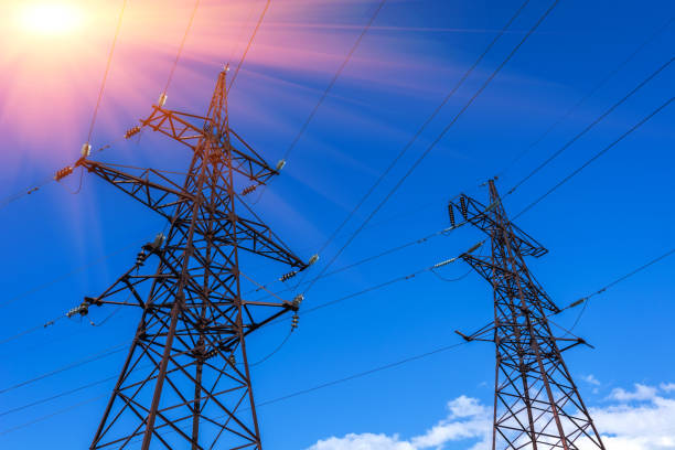 istock High-voltage lines against the blue sky, green  forest at sunset. 821648624