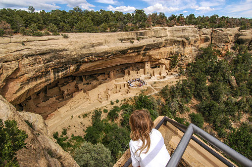 Young boy looking down of the fanous Cliff Palace in Mesa Verde National Park, Colorado. American Sountwest.