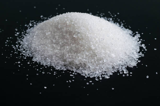 istock Heap of granulated sugar isolated on black 821661948